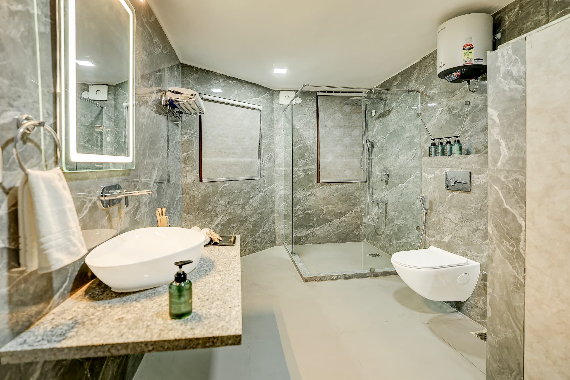 Ensuite bathroom in grey marble with walk-in glass shower